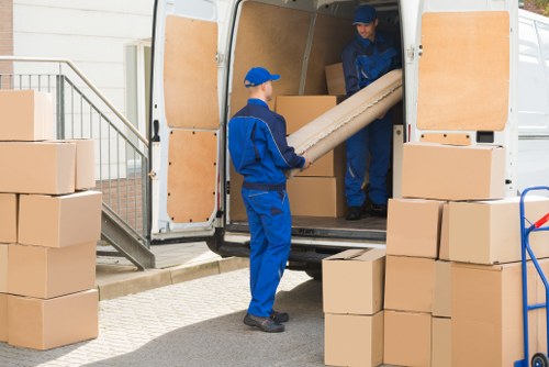 Office relocation team preparing desks and boxes for a Queens Park business move
