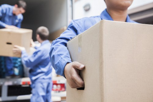 Local moving team handling furniture in Queens Park