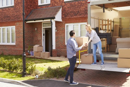 Moving team handling boxes safely during a Queenspark van service