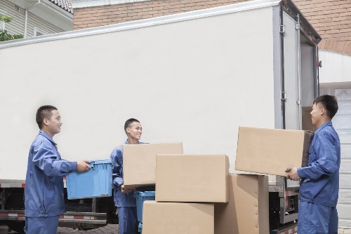 Professional movers organising packed belongings in Queens Park