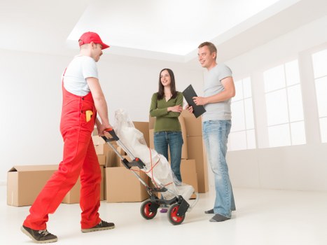Packing and removals support for a Queens Park house move with boxes and furniture