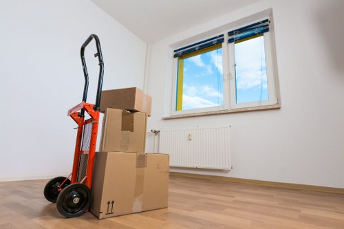 A mover navigating stairs with furniture in a Queenspark property