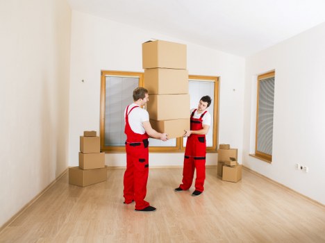 Packed moving boxes and furniture ready for house removals in Queens Park