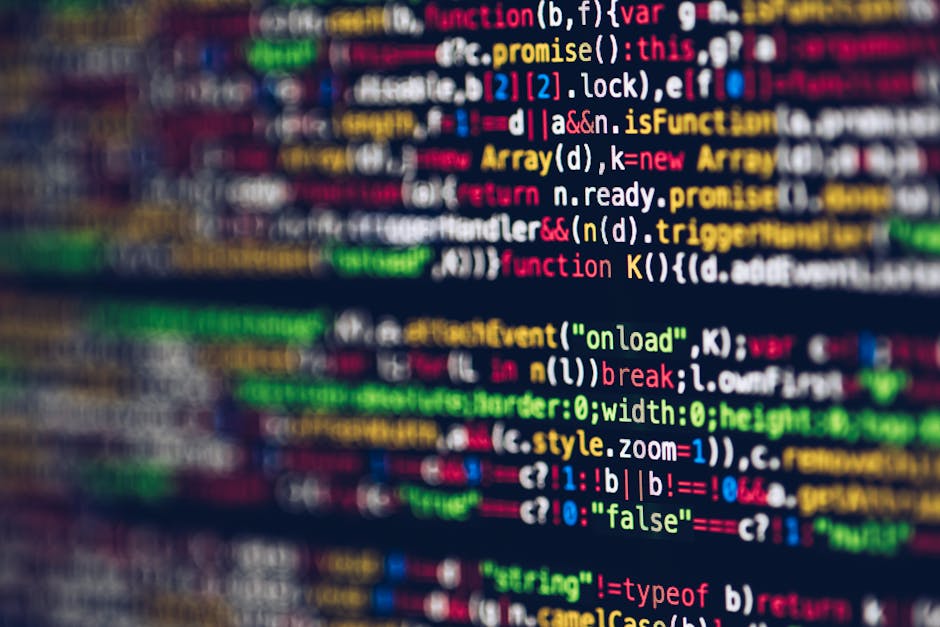A close-up photograph of a computer screen displaying lines of HTML code with various tags and attributes in multiple colors, including `<h1>`, `<div>`, and `<img>`, with some image source links visib
